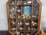 a small display case with a lot of small figurines in it