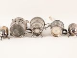 a group of silver objects on a white surface