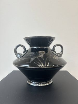 a black vase sitting on top of a black table