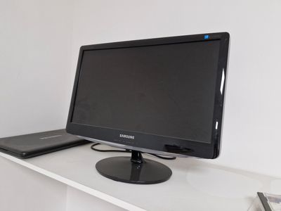 a computer monitor sitting on top of a white desk