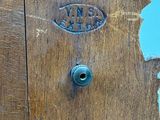 a close up of a wooden door with a hole in it