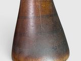 a wooden vase that is sitting on a white surface