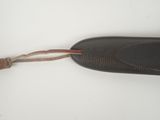 an old pair of black shoes with brown laces on a white surface