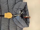 a jacket with a tag attached to it that is attached to the back of a jacket