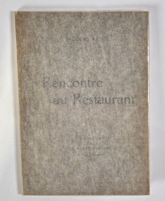 an old book sitting on top of a table next to a white wall