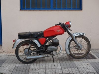 a red motorcycle parked on the side of the street