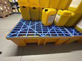 a yellow container sitting on top of a pallet next to other yellow containers