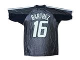 the shirt is black and white with a number 16 on it