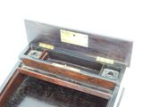 a wooden box with a metal latch on top of it