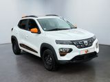 the white and orange dacia is parked in a white room