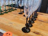 many wine glasses sitting on a table with a price tag