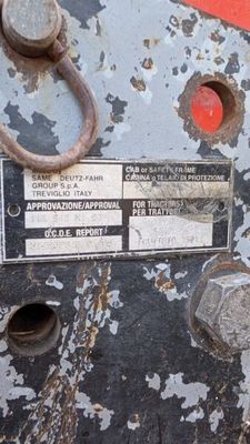a close up of a rusted machine with a label on it