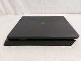 a black laptop sitting on a white surface