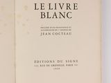 the book is open on a white surface with a black and white image