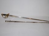 two swords with a gold handle on a white surface