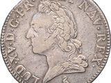 a silver coin with the head of a man in profile
