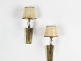 pair of brass sconces with lamps on a white wall