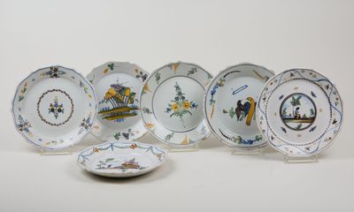 several plates with different designs and designs on them on a white surface