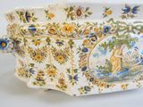 a large white bowl with a blue and yellow design on it