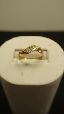 an image of a gold ring sitting on top of a white box