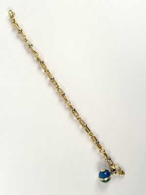 gold plated bracelet with a blue glass bead and a gold chain