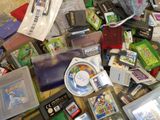 a pile of video games and other items on the floor