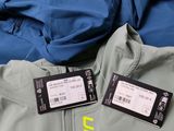 two tags attached to the back of a jacket