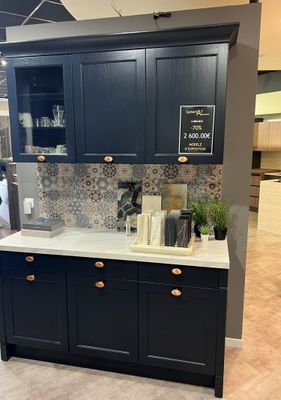 an image of a kitchen with black cabinets and white counter tops