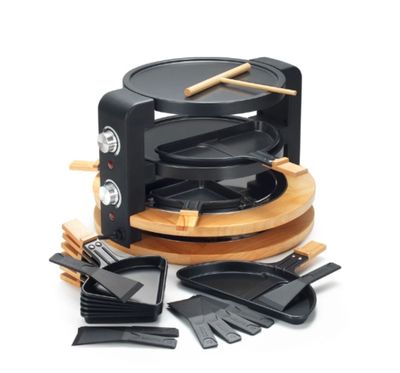 an image of a black and wood grill set with spatulas