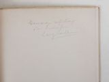 an open book with a handwritten title on it sitting on a table