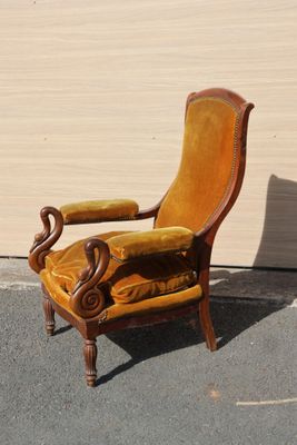a yellow chair that is sitting in the middle of the street