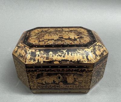 an image of a black and gold box sitting on top of a table