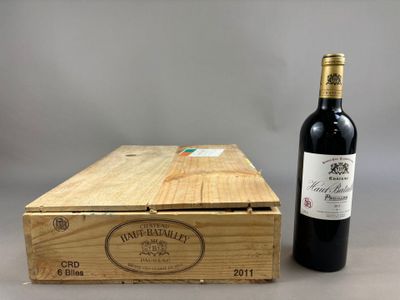 a bottle of wine sitting next to a wooden box