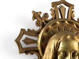 a gold statue of a woman with a crown on her head