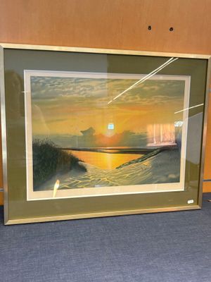 une photo d'une photo d'un coucher de soleil accrochée au mur