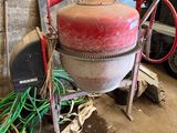 a red fire hydrant sitting in a garage next to a pile of wires