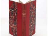 a red book that is open on a white surface