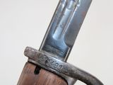 a close up of a knife on a wooden pole