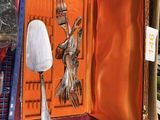 an orange case with a silver spoon and a fork inside of it