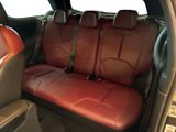 the back seats of a car with red leather seats in the back