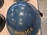 several police helmets are lined up on a table in a room