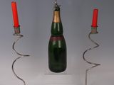 bottles of wine and a candelab are sitting on a table