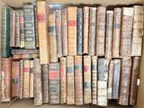 a box full of old books sitting on the floor