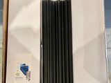 a box with a bunch of black pencils in it
