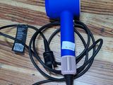 a blue blow dryer sitting on top of a wooden floor