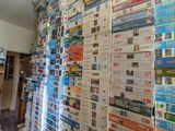 a lot of books stacked on top of each other in a room
