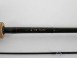 a close up of a fishing rod on a white surface