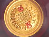 a close up of a bottle of wine with a gold label