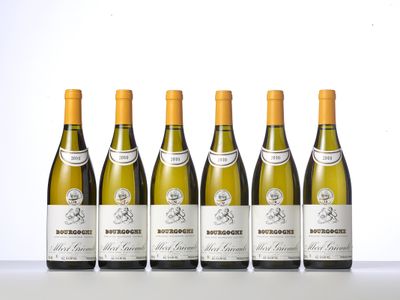 six bottles of white wine lined up in a row