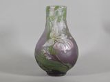 a purple vase with white flowers on it on a white background